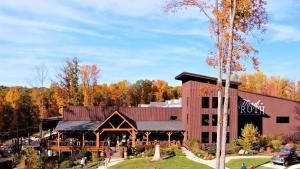 a resort with a large building with trees in the background at Lake House in Nashville