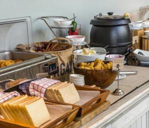 a buffet with bread and other food on a table at Cabañas del globero in Uspallata