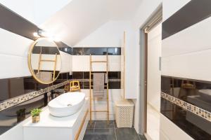 un bagno con lavandino e specchio di La Suite Golden a Schœlcher