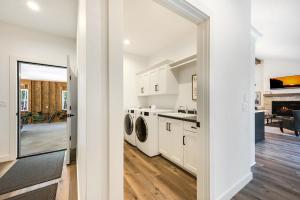 a white kitchen with a washer and dryer at Luxury Retreat with Hot Tub The Ephraim House in Ephraim