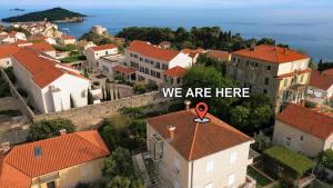 a city with a sign that says we are here at Villa Falkoni II in Dubrovnik +49 photos