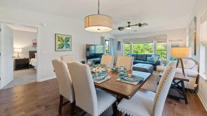 a dining room and living room with a table and chairs at 55F Pawleys After Dark condo by Peace Vacations in Pawleys Island +23 photos