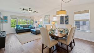 a dining room and living room with a table and chairs at 55F Pawleys After Dark condo by Peace Vacations in Pawleys Island