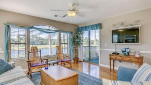 a living room with a couch and a table at 57C Fifty-Seven Sea II at True Blue condo by Peace Vacations in Pawleys Island
