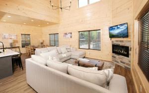 a living room with a couch and a fireplace at Smoky Mountain Oasis in Pigeon Forge