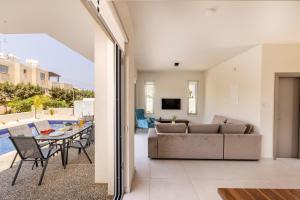 a living room with a couch and a table at Protaras Mythical Seas in Protaras