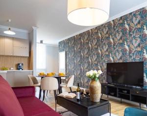 un salon avec un canapé et une télévision dans l'établissement NiMFa THE BEST - EXLUSIVE 10, à Kudowa-Zdrój