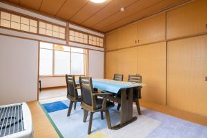 a dining room with a table and chairs at 巴ドットcom Premium Stay in Hakodate