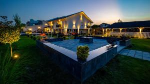 a large house with a backyard at night at Casa Cristian Wellness & Spa in Haţeg