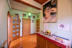 a room with a counter and a picture of a woman on the wall at Tomoeドットコム3 music stay in Hakodate +24 photos