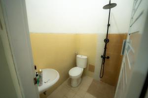 a small bathroom with a toilet and a sink at House Shizen I in Uluwatu