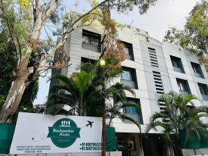a building with a sign in front of it at Backpacker Hostel in Pune