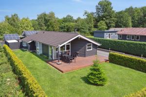 a backyard with a house with solar panels on it at Luxury House Spasauna, Carcharger, River in Fårvang
