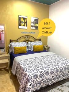 a bedroom with a bed with a poster on the wall at Nadialisa cottage homestay For Islamic only in Sungai Petani