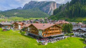 an aerial view of a village in the mountains at Freina Mountain Lifestyle Hotel in Selva di Val Gardena