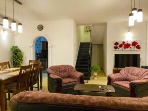 a living room with a table and chairs and a dining room at The Sea Breeze - Down Stairs in Panadura