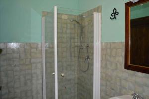 a bathroom with a shower with a glass door at Apartment in Asciano - Toskana 50686 in Asciano +24 photos