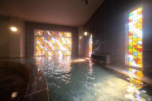 a room with a pool with stained glass windows at Boyokaku in Amakusa