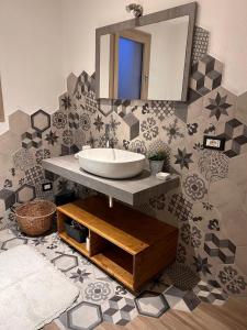 a bathroom with a sink and a mirror at Villa pirastu in Bassacutena +37 photos