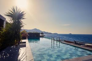 a swimming pool with a view of the ocean at Root Redrock Yalıkavak in Yalıkavak