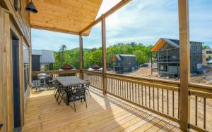 a large deck with a table and chairs on it at Smoky Mountain Oasis in Pigeon Forge