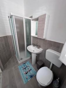 a bathroom with a toilet and a sink and a shower at Casa di Pippo in Trappeto