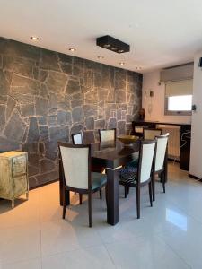 a dining room with a table and chairs at Moderno piso con vista al río en zona residencial in San Nicolás de los Arroyos +6 photos