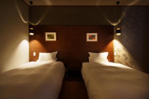 Voodi või voodid majutusasutuse Kintarou Onsen Hotel toas