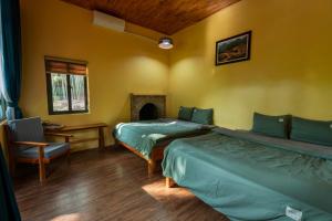 Ένα ή περισσότερα κρεβάτια σε δωμάτιο στο Cinnamon Eco Lodge