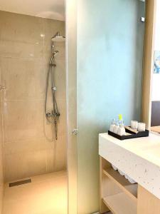 a bathroom with a shower and a sink at Holi Arena Cam Ranh Seaview Premier Apartment in Thôn Hòa Ða