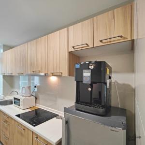 a kitchen with a coffee maker on top of a refrigerator at D'Esplanande Residence Homestay by WELCOME HOME in Johor Bahru