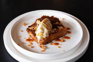 a white plate with a piece of dessert on it at Logis - Hôtel & Restaurant Le Bellevue in La Bouille