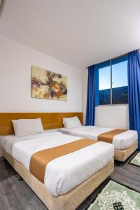 Postel nebo postele na pokoji v ubytování Nunuk Ragang Hotel