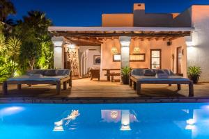 a villa with a swimming pool next to a house at VILLA SERENITY 3 Luxury boutique villa in Sant Jordi