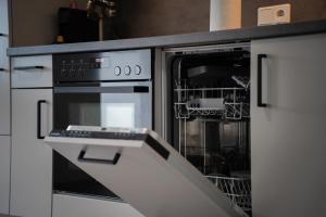 Kuchyň nebo kuchyňský kout v ubytování JUNIK Apartments Oberhausen