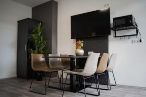 TV a/nebo společenská místnost v ubytování JUNIK Apartments Oberhausen