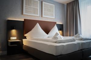 Postel nebo postele na pokoji v ubytování JUNIK Apartments Oberhausen