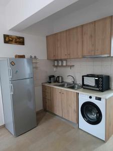 a kitchen with a refrigerator and a washing machine at Ascension Corfu Studios by GuestCorfu in Análipsis
