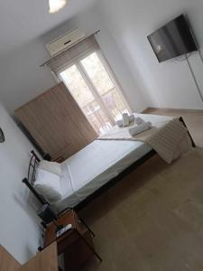 a bedroom with a large bed with a window at Ascension Corfu Studios by GuestCorfu in Análipsis