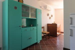 a green cabinet in a room with a table at Casa Franguella - Uliveto sul mare in Lavagna +19 photos