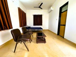 a room with a ping pong table and chairs at Ranjan Vadi in Bhuj