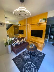 a living room with a couch and a table at Chic Haven-Deluxe Staycation in Pagadian in Pagadian
