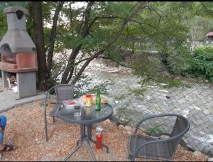 a table and chairs with drinks on a patio at Căsuțele de vară in Vişeu de Sus