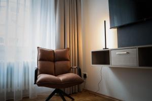 TV a/nebo společenská místnost v ubytování JUNIK Apartments Oberhausen