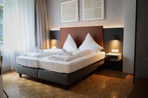 Postel nebo postele na pokoji v ubytování JUNIK Apartments Oberhausen