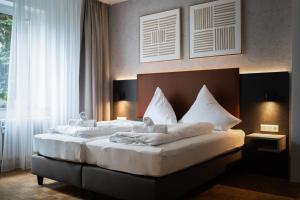 Postel nebo postele na pokoji v ubytování JUNIK Apartments Oberhausen