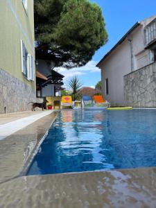 a swimming pool in the middle of a house at Apartments Villa-G Lustica in Tivat