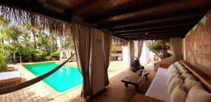 a porch with a hammock and a swimming pool at VILLA SERENITY 3 Luxury boutique villa in Sant Jordi