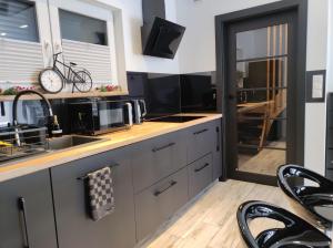 a kitchen with a sink and a counter top at Domki u Duszy in Brenna