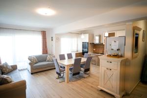 a living room with a dining table and a kitchen at Hunyadi Luxury Dna Stanca 1 in Sibiu